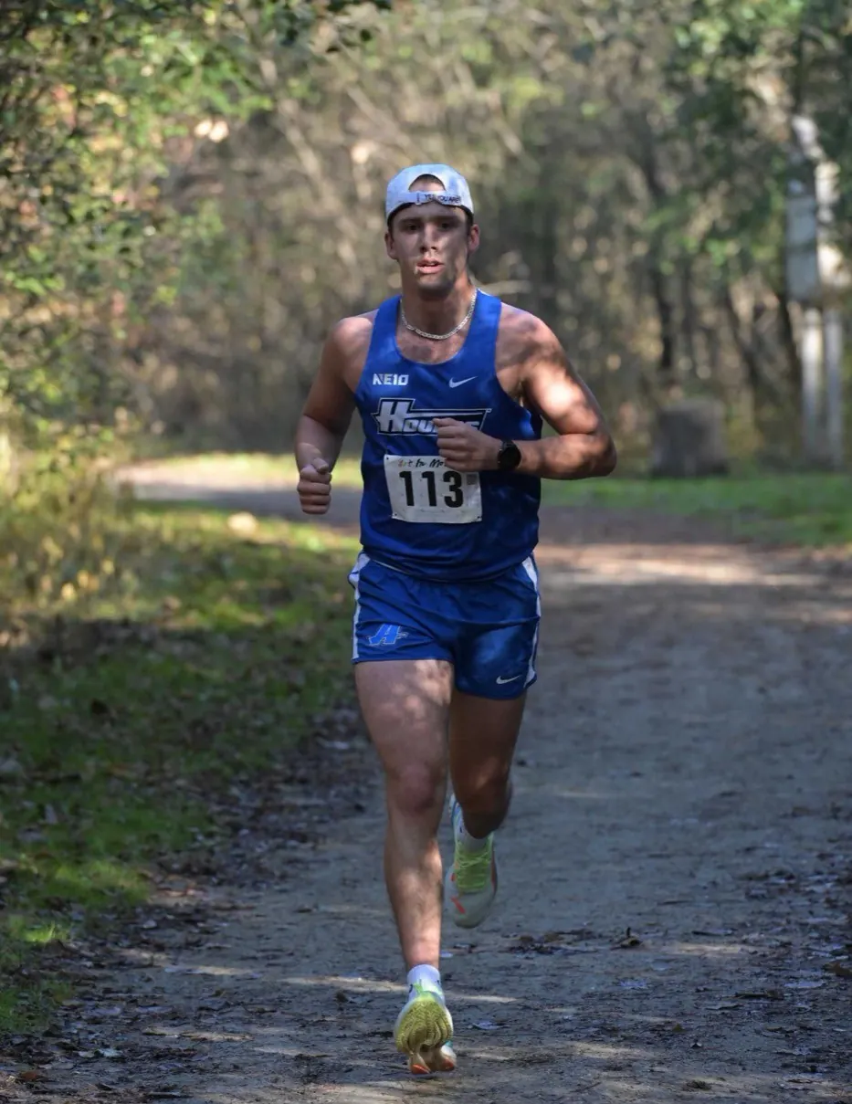 Shawn Scullion racing in an Assumption University singlet