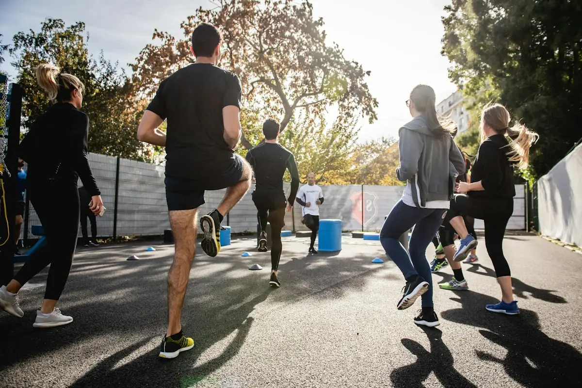 A group running together along a tree-lined path
